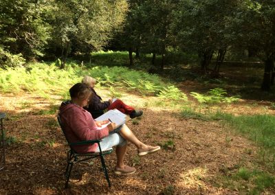 Learning Permaculture in nature two students sitting in the shade